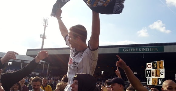 Promotion celebrations in 2013 at the Port Vale v Northampton Town game. Tom Pope held aloft.