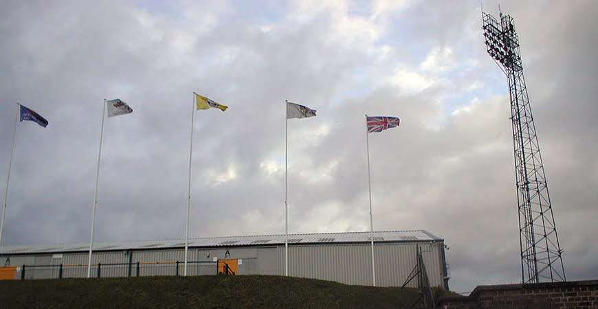 Flags fly at the back of Port Vale's Railway Stand