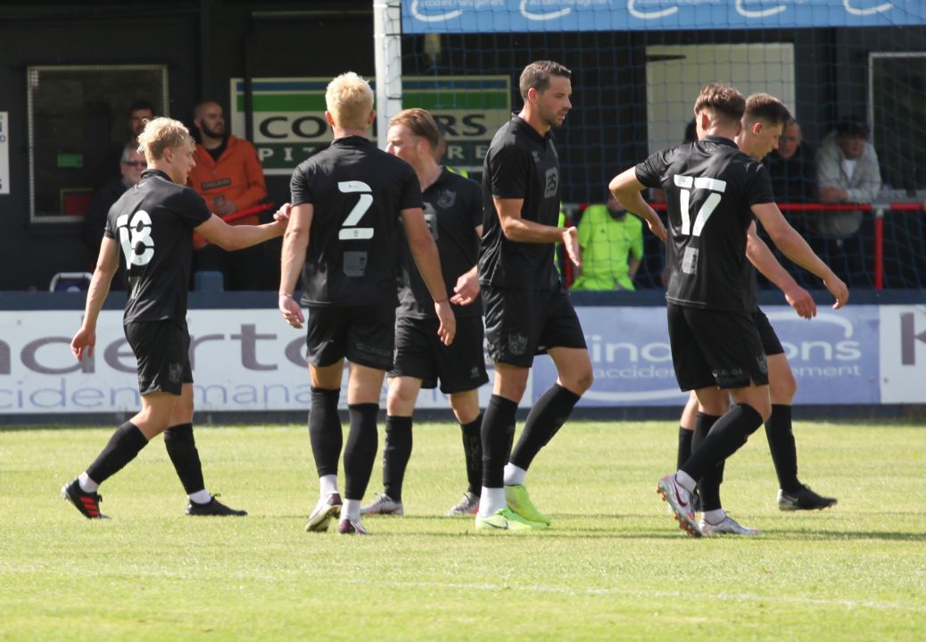 Eden Bailey (left) is congratulated for a goal against Kidsgrove Athletic in 2021