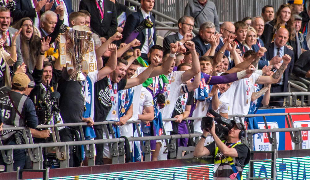 Port Vale players celebrate promotion at Wembley stadium, 2022