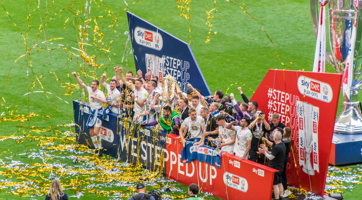 The Port Vale team celebrate promotion at Wembley stadium, 2022